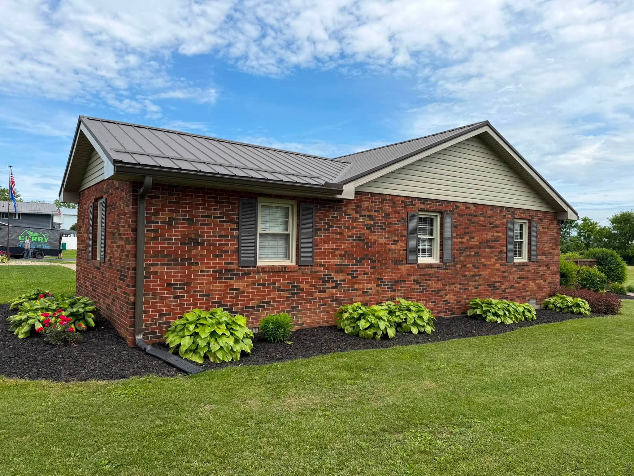 Brick home with finished metal roof
