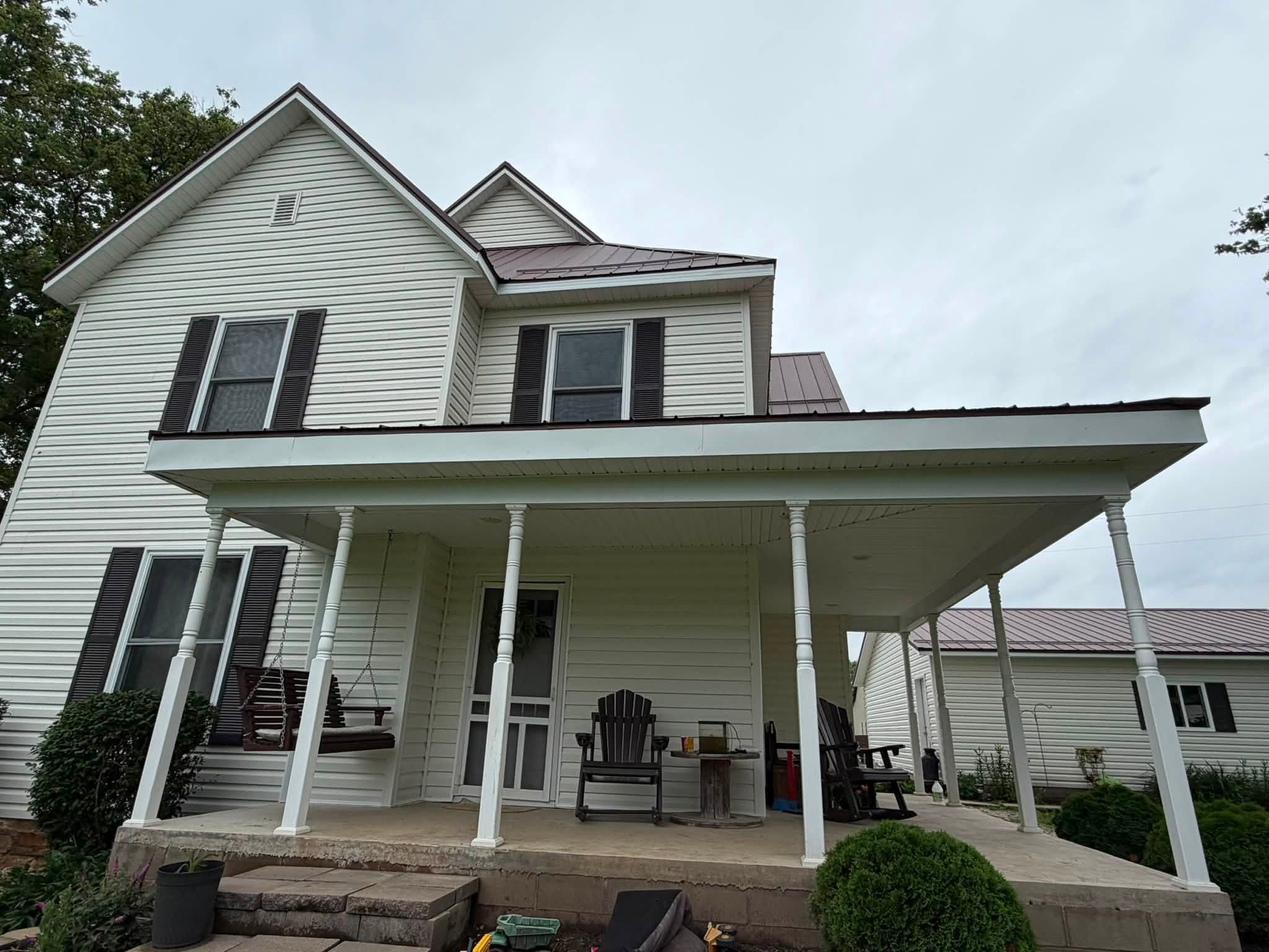 White farmhouse front porch and metal roof