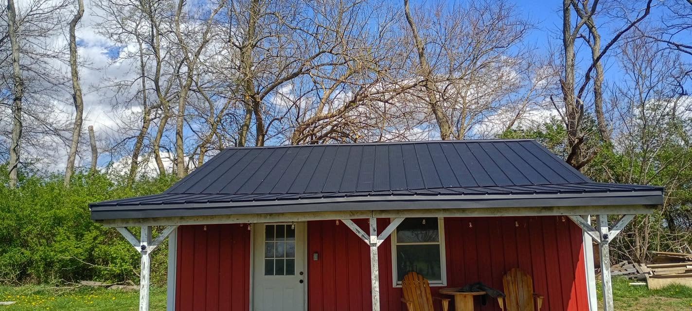 Red barn with black metal roof