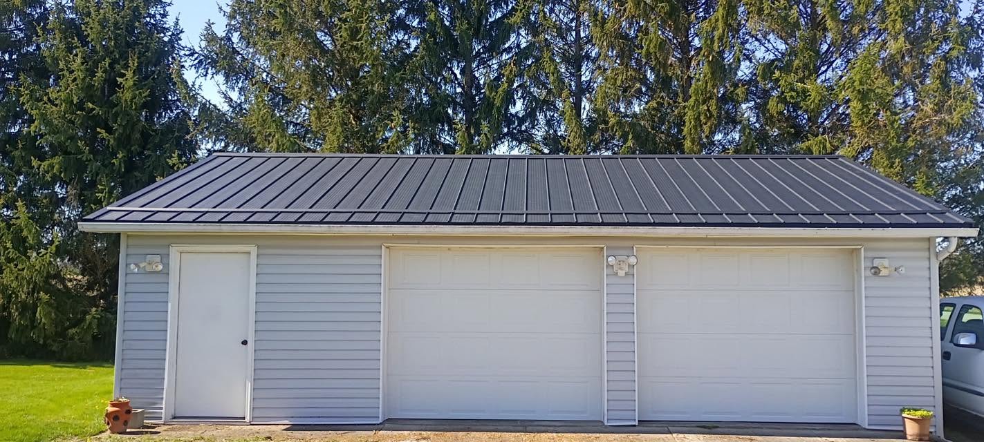 White garage with black metal roof